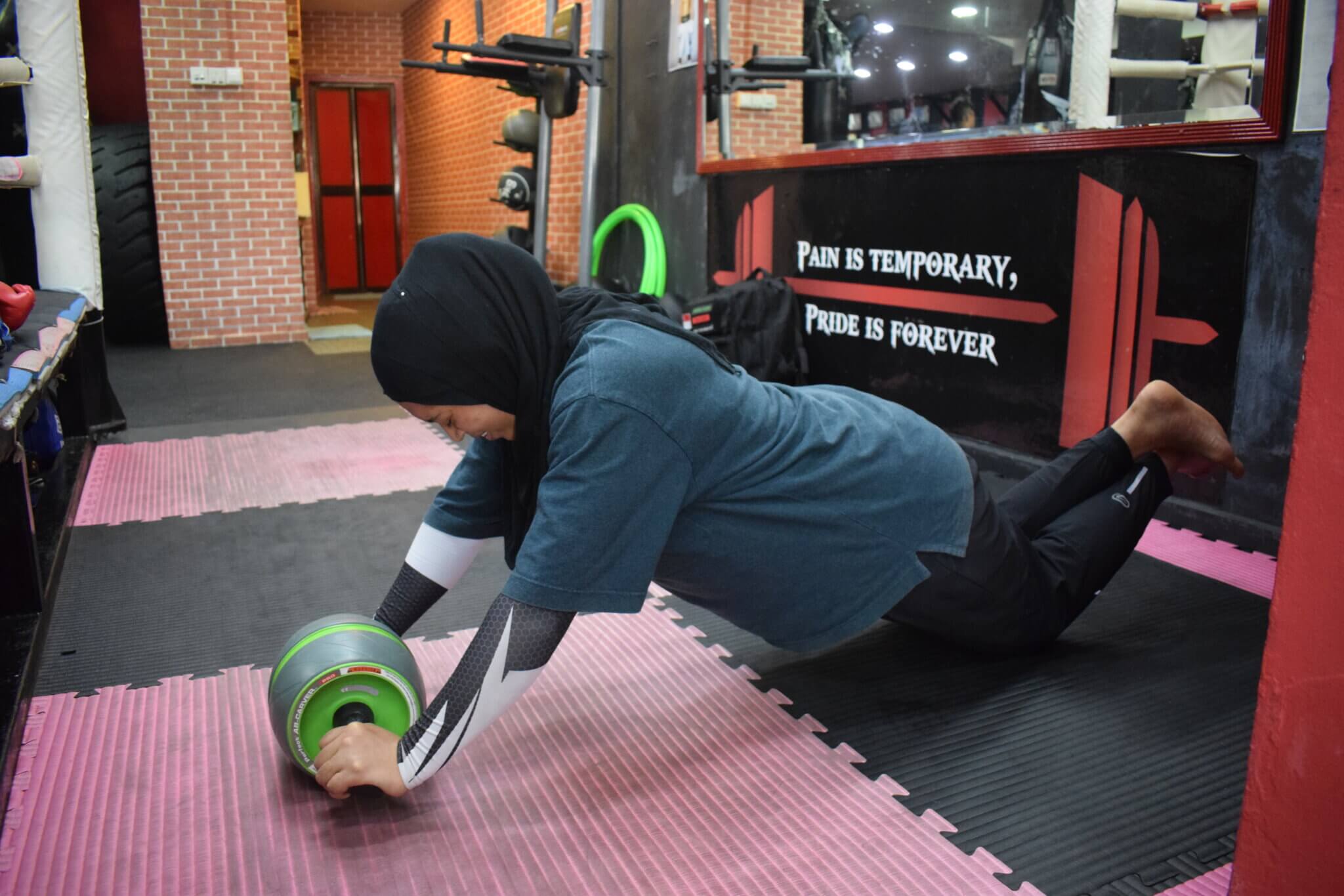 Student Demonstrating a Push-Up Wheel Exercise